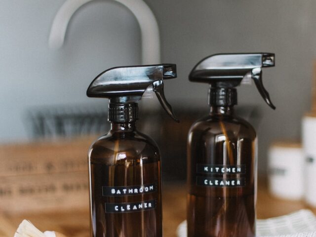 two brown spray bottles on brown table